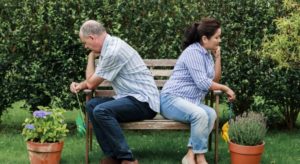 unhappy couple sitting on bench marriage counseling