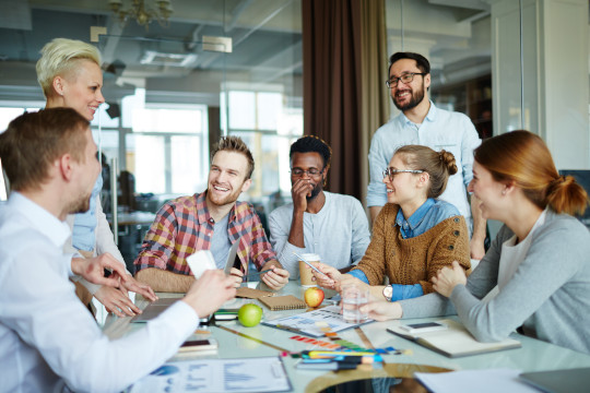 a group of professionals smiling at each other in a meeting at the table divorce in florida cost