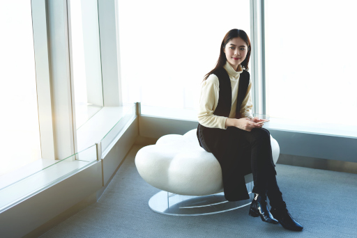 A woman sitting on a chair smiling divorce in florida cost