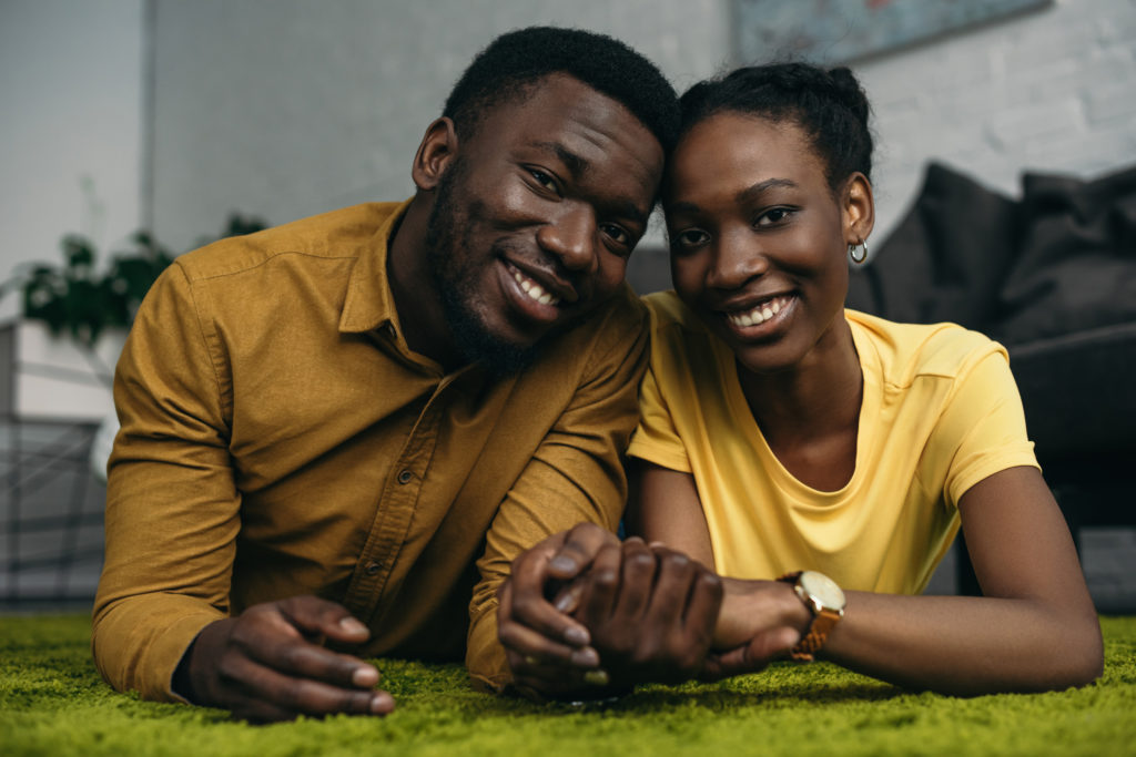 couple holding their hands and smiling divorce attorney