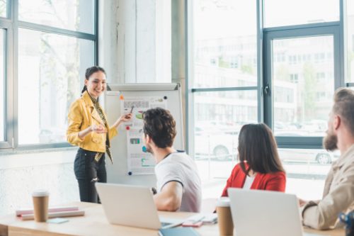 woman presenting in front of her 3 workmates mediator for divorce