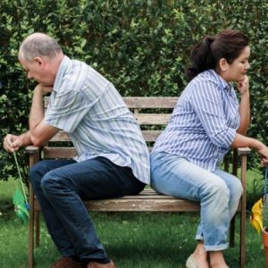 unhappy couple sitting on bench marriage counseling